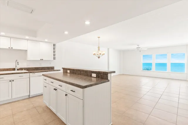 a kitchen with granite countertop a sink and cabinets