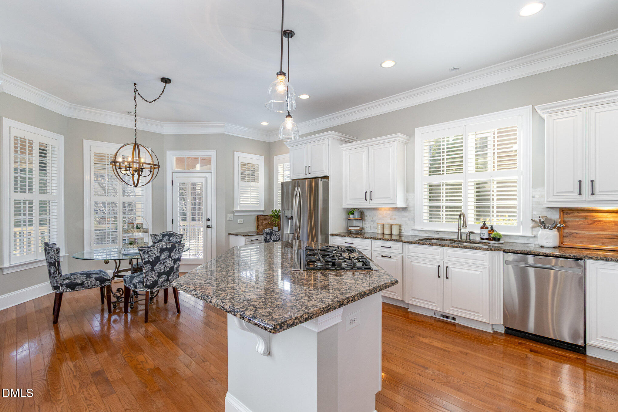 8517 Stonechase Drive Raleigh, NC 27613 - Photo 11 of 37 a kitchen with center island table and chairs