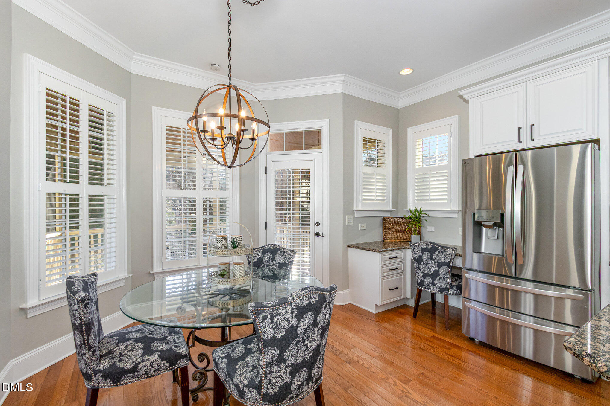 8517 Stonechase Drive Raleigh, NC 27613 - Photo 12 of 37 a dining room with furniture a chandelier and wooden floor
