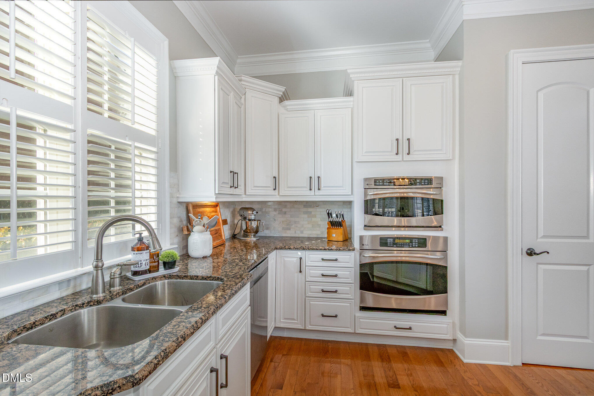 8517 Stonechase Drive Raleigh, NC 27613 - Photo 13 of 37 a kitchen with stainless steel appliances granite countertop a sink stove and cabinets
