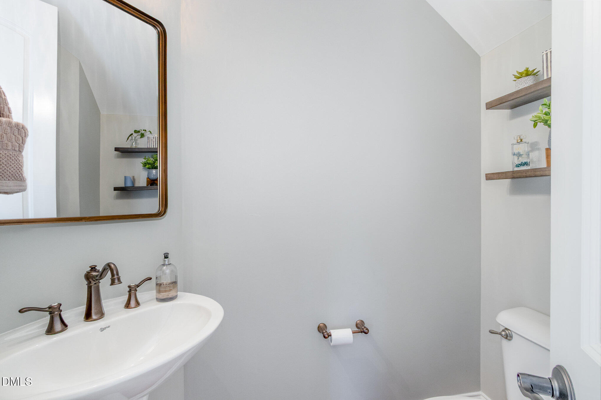 8517 Stonechase Drive Raleigh, NC 27613 - Photo 18 of 37 a bathroom with a sink and a mirror