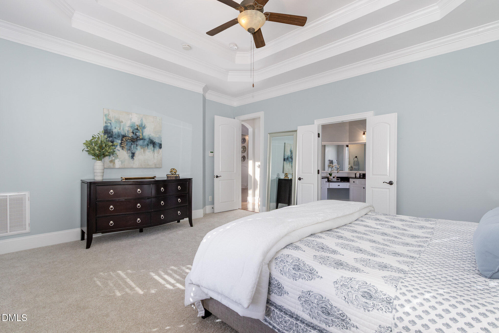 8517 Stonechase Drive Raleigh, NC 27613 - Photo 25 of 37 a bedroom with a bed and a chandelier