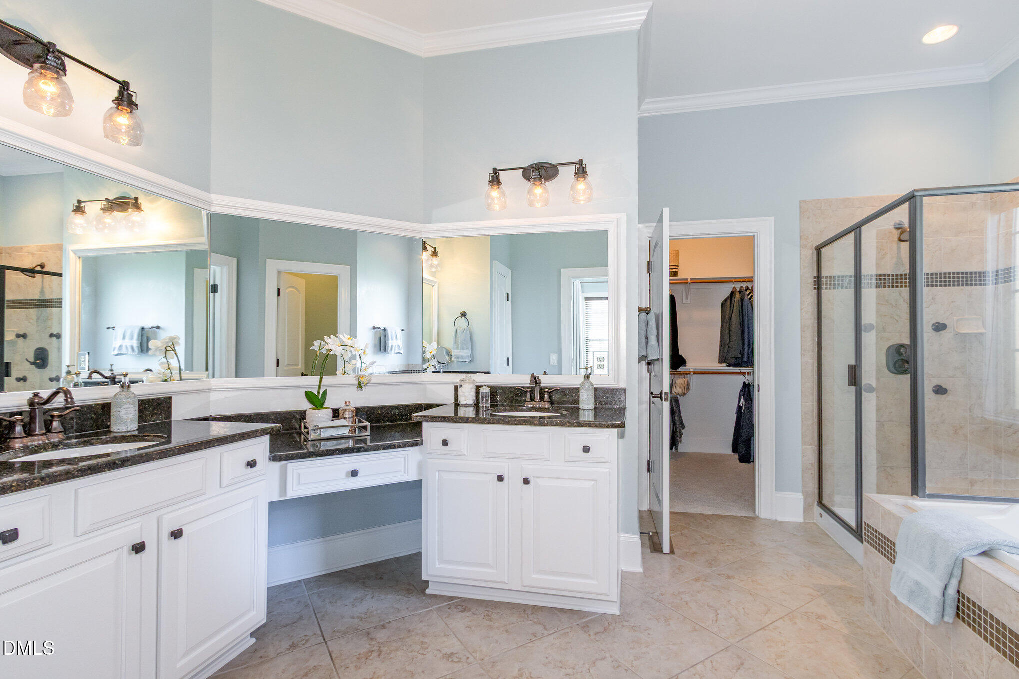 8517 Stonechase Drive Raleigh, NC 27613 - Photo 26 of 37 a spacious bathroom with a granite countertop sink and a mirror