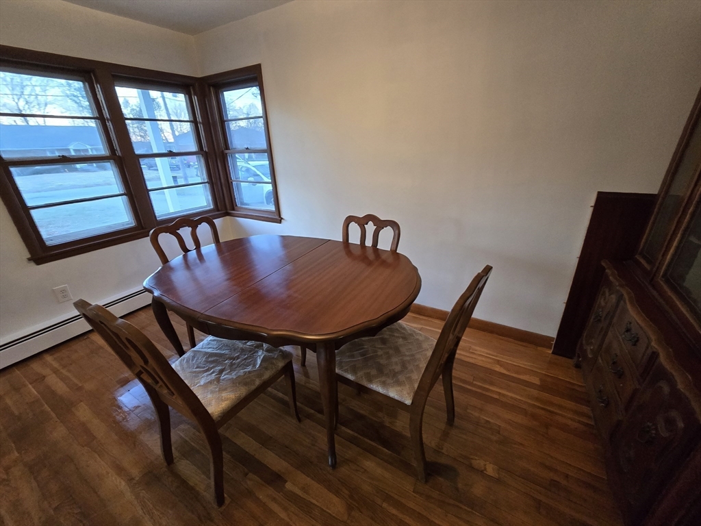 24 Pepka Drive Webster, MA 01570 - Photo 10 of 14 a view of a dining room with furniture wooden floor and a potted plant