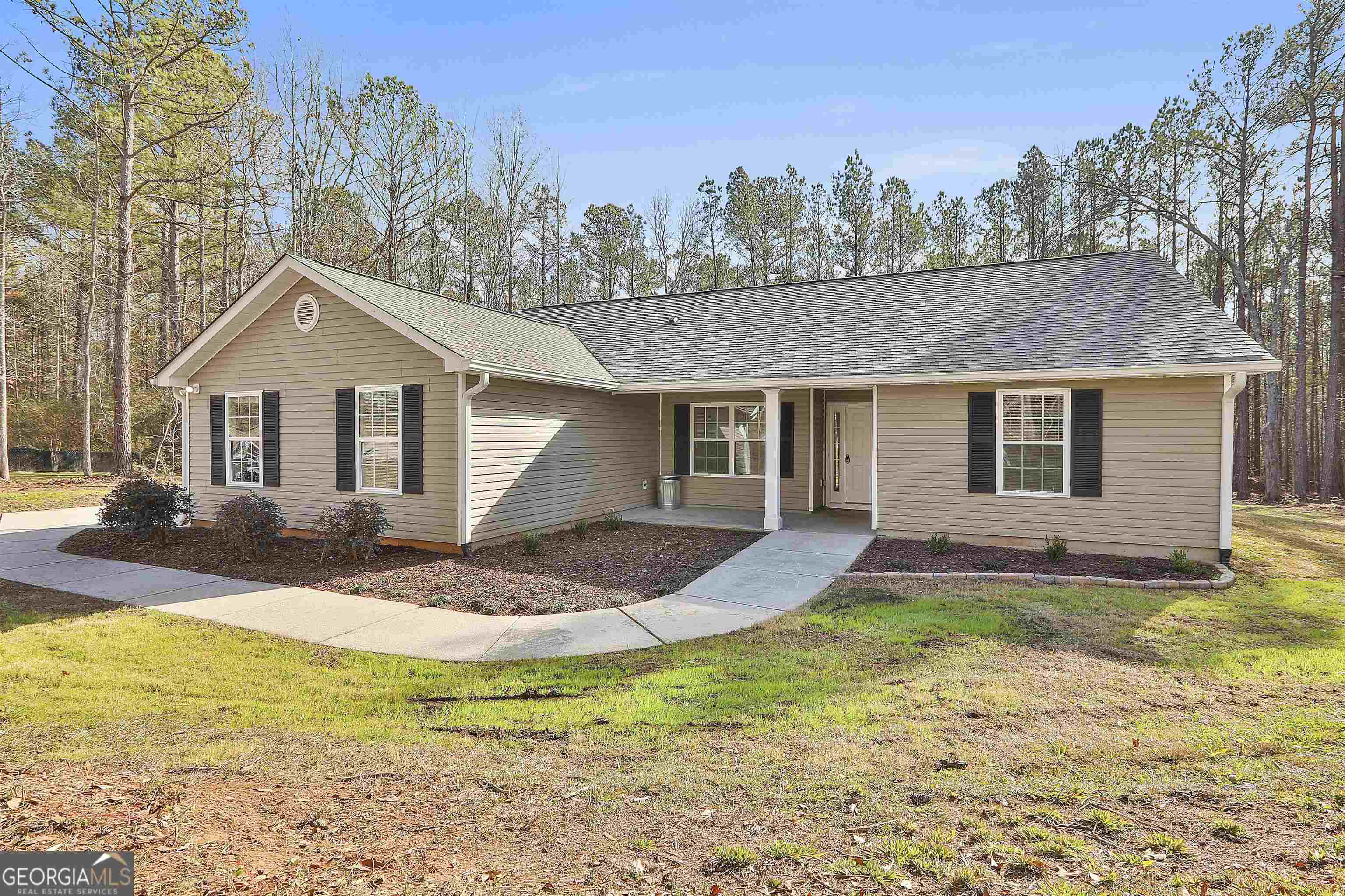 220 Sanders-Davis Road Newnan, GA 30263 - Photo 1 of 1 a front view of a house with a garden and yard