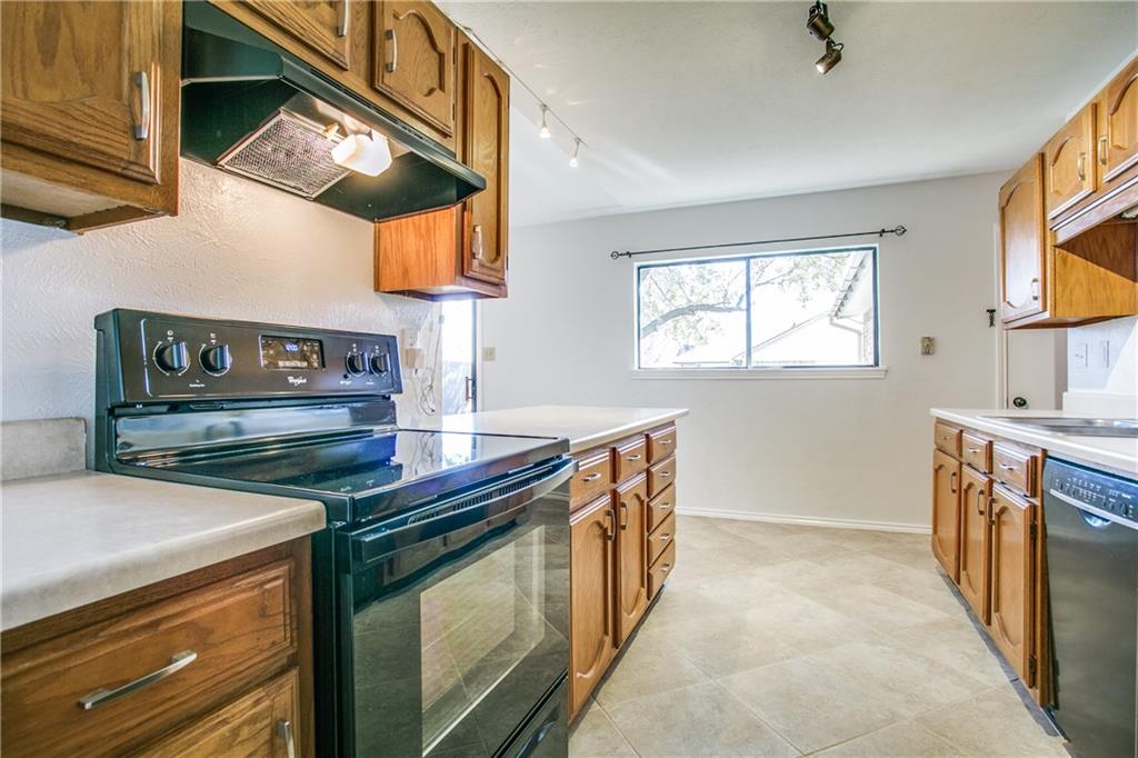 1318 Springview Drive Allen, TX 75002 - Photo 14 of 35 a kitchen with stainless steel appliances granite countertop a stove and a sink