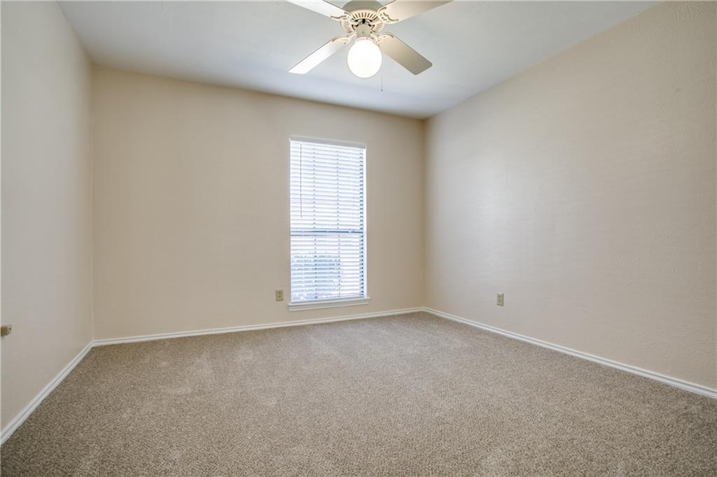 1318 Springview Drive Allen, TX 75002 - Photo 18 of 35 an empty room with a chandelier fan and windows