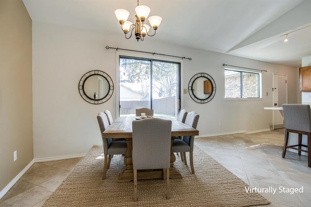 1318 Springview Drive Allen, TX 75002 - Photo 22 of 35 a view of a dining room with furniture a chandelier and wooden floor