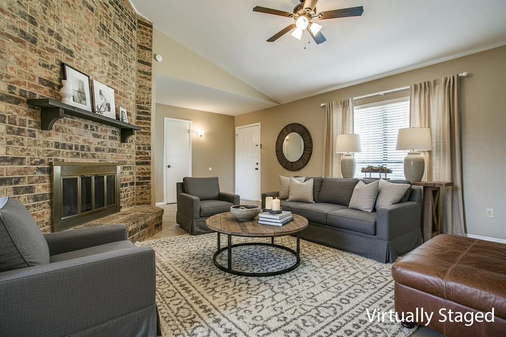 1318 Springview Drive Allen, TX 75002 - Photo 4 of 35 a living room with furniture and a fireplace