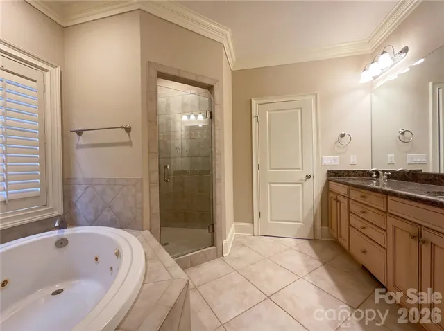 a spacious bathroom with a tub shower and sink