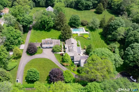an aerial view of a house with yard swimming pool and outdoor seating