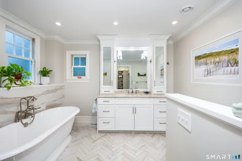 a spacious bathroom with a granite countertop tub sink a mirror a vanity and a shower