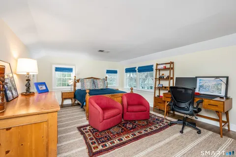 a living room with furniture gym equipment and a rug