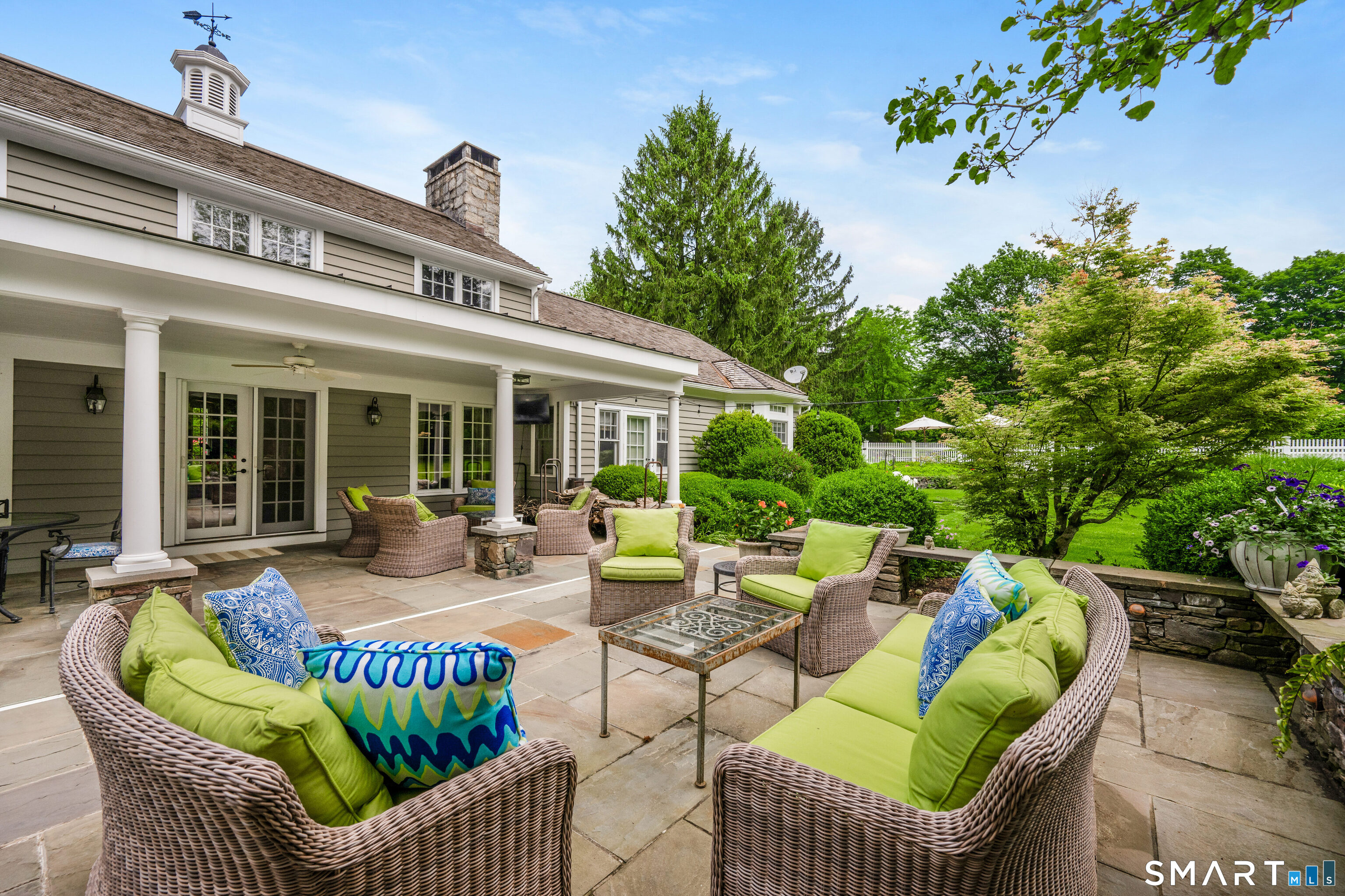 246 Brookside Road Darien, CT 06820 - Photo 26 of 40 a view of a patio with couches table and chairs and potted plants