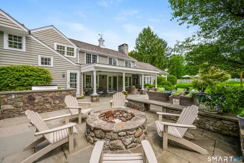 a view of a house with backyard sitting area and garden