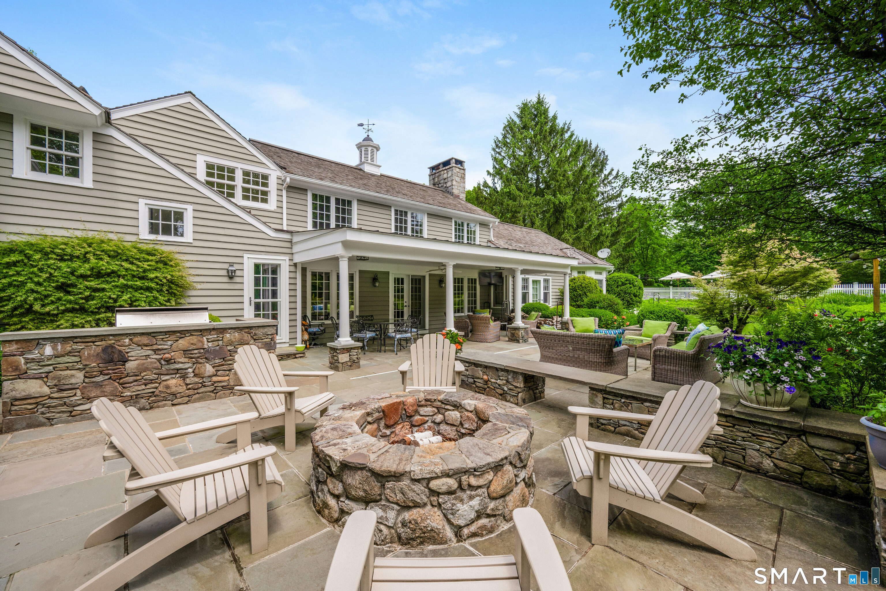 246 Brookside Road Darien, CT 06820 - Photo 27 of 40 a view of a house with backyard sitting area and garden