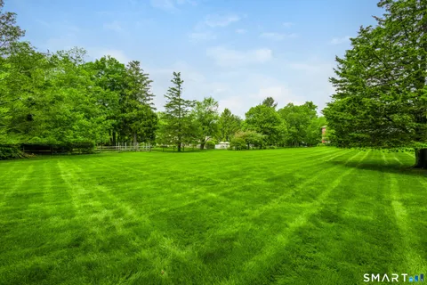a backyard of a house with lots of green space and garden
