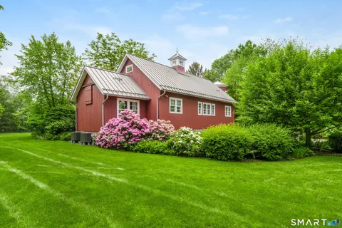 a front view of a house with a garden and plants