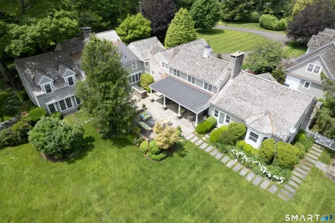 an aerial view of a house with a yard and lake view
