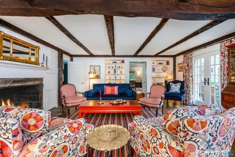 a living room with furniture fireplace and flat screen tv