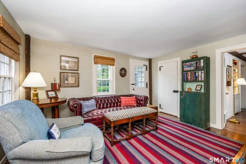 a living room with furniture and a rug