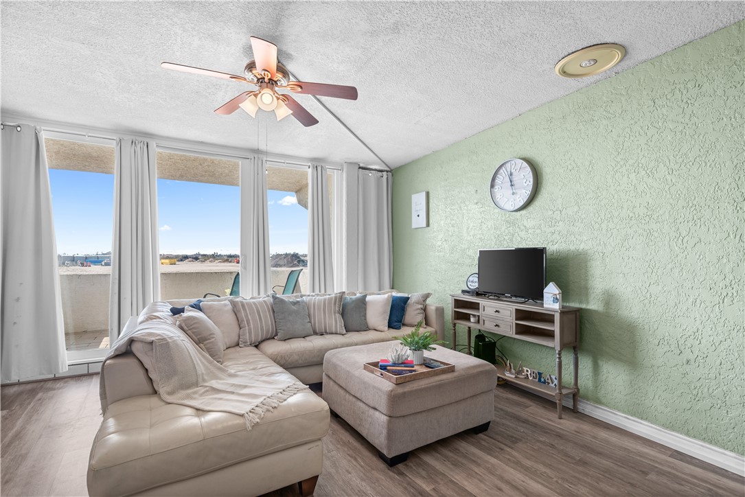14401 Commodores Drive, Unit 101 Corpus Christi, TX 78418 - Photo 15 of 26 a living room with furniture a flat screen tv and a window