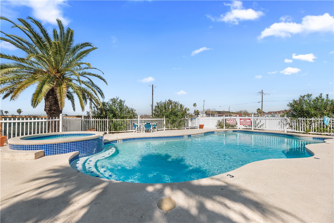 14401 Commodores Drive, Unit 101 Corpus Christi, TX 78418 - Photo 4 of 26 a view of a backyard and swimming pool