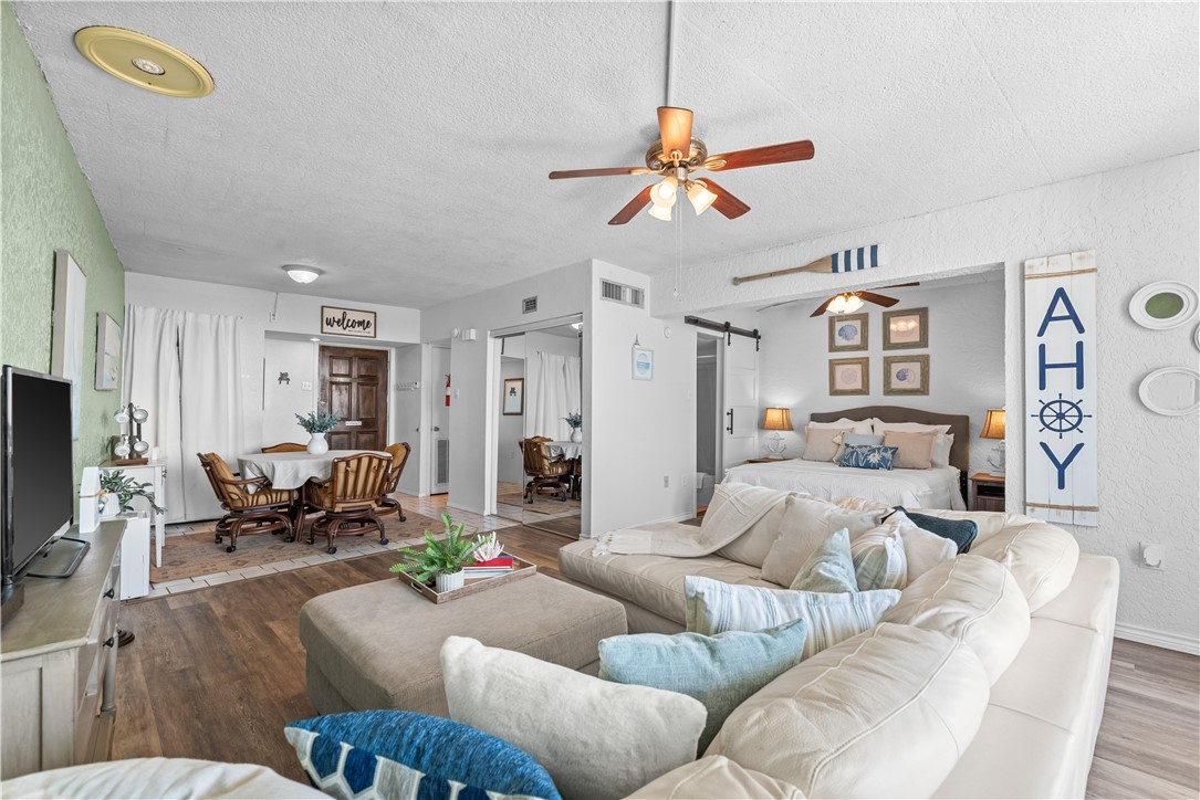 14401 Commodores Drive, Unit 101 Corpus Christi, TX 78418 - Photo 7 of 26 a living room with furniture and a flat screen tv