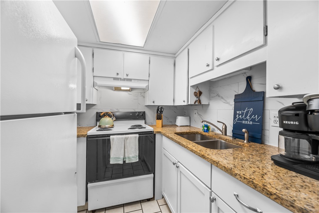 14401 Commodores Drive, Unit 101 Corpus Christi, TX 78418 - Photo 9 of 26 a kitchen with a sink and cabinets