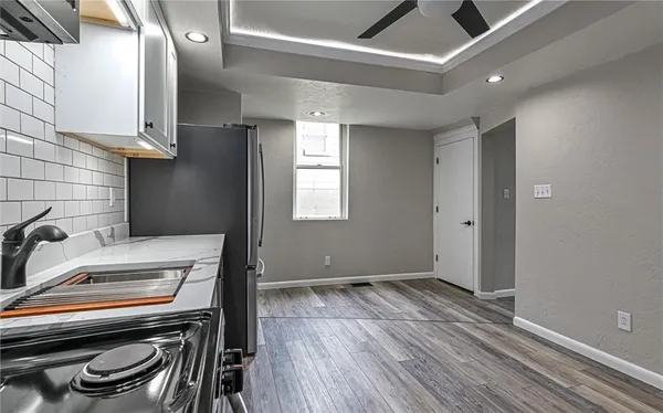 a room with a stove and a wooden floor
