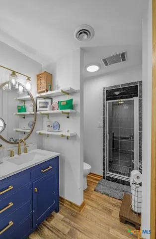 a bathroom with a granite countertop sink mirror and vanity