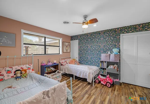 a bedroom with furniture and a window