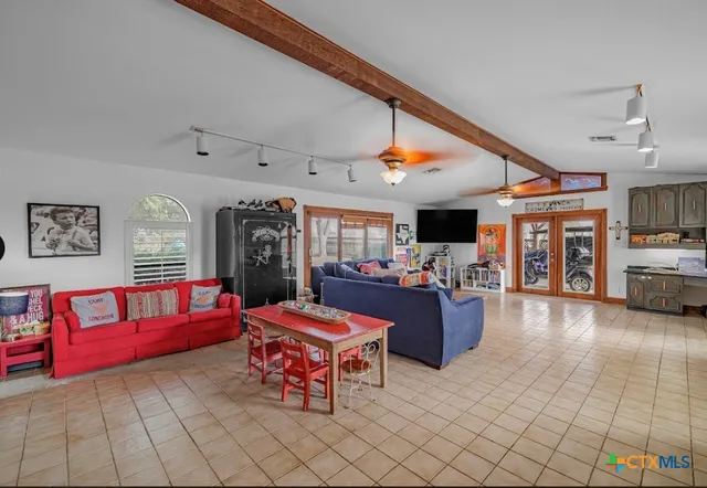 a living room with furniture and flat screen tv