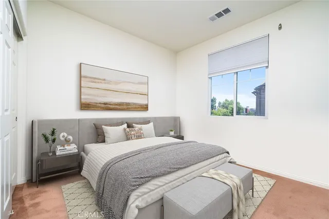 a bedroom with a bed and a painting on the wall