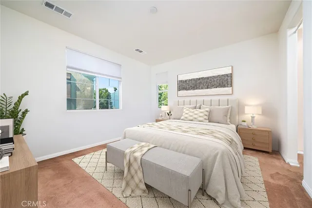 a bedroom with a bed and a potted plant
