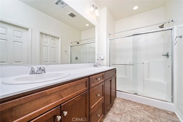 a bathroom with a granite countertop sink mirror and double