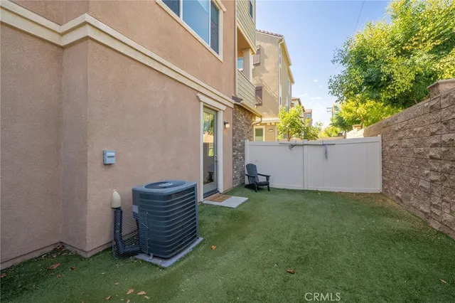 a view of a backyard with plants and a large tree