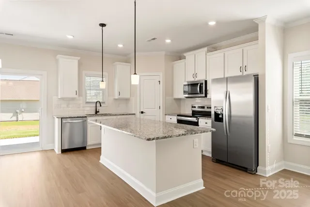 a kitchen with a refrigerator sink and stove