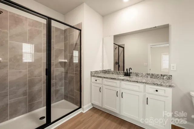 a bathroom with a granite countertop sink mirror and double