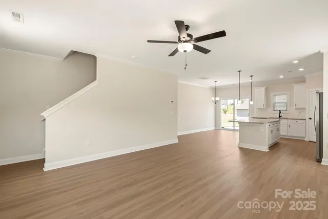 a view of a kitchen with wooden floor and a sink