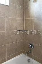 a bathroom with a shower and a sink