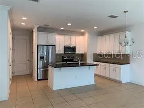 a kitchen with stainless steel appliances granite countertop a refrigerator and a stove