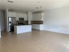a kitchen with stainless steel appliances a refrigerator and a sink