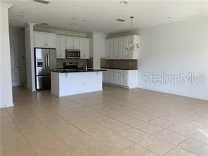 a large kitchen with cabinets stainless steel appliances and a window