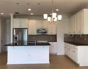 a kitchen with stainless steel appliances a counter space a sink and cabinets