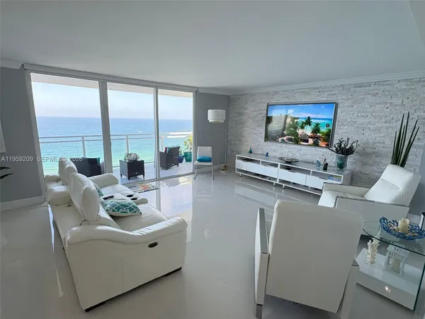 a living room with furniture a flat screen tv and a large window