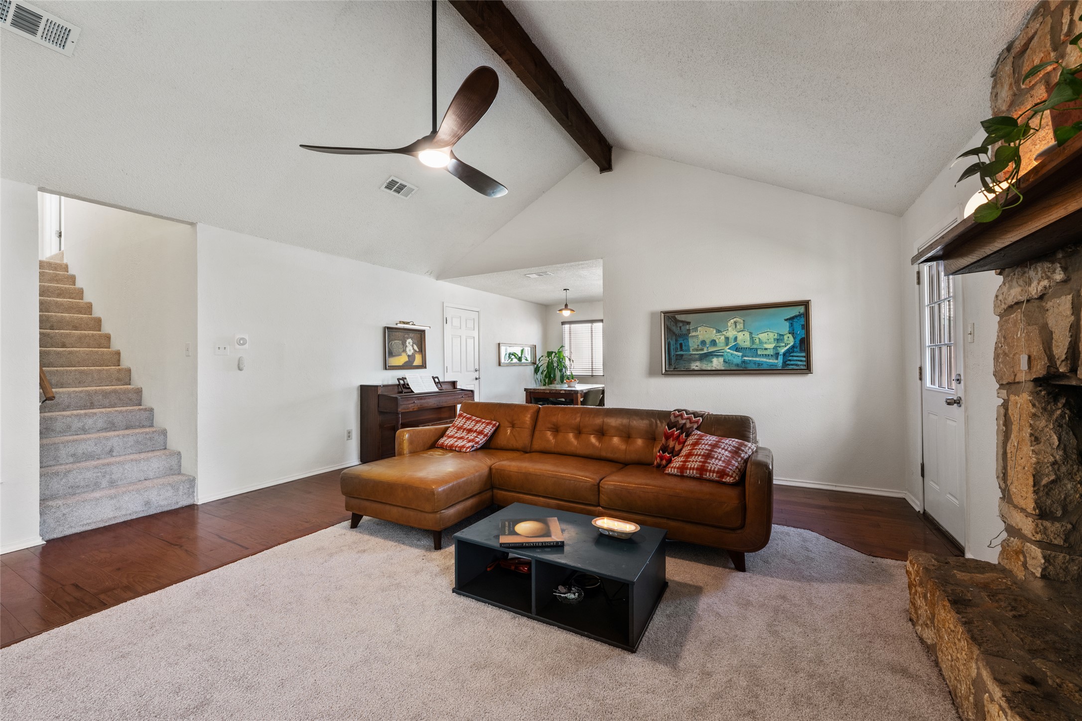 5100 Lambs Lane Austin, TX 78744 - Photo 12 of 31 Living room with vaulted ceiling, wood-style floors, healthy amount of natural light and ceiling fan.