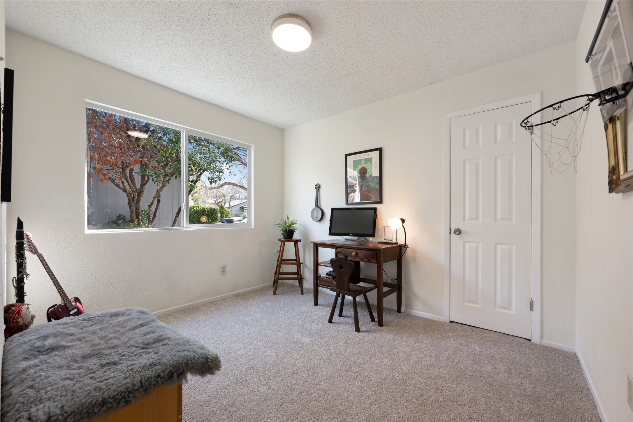 5100 Lambs Lane Austin, TX 78744 - Photo 17 of 31 A secondary bedroom downstairs, with loads of natural light and fresh carpet.