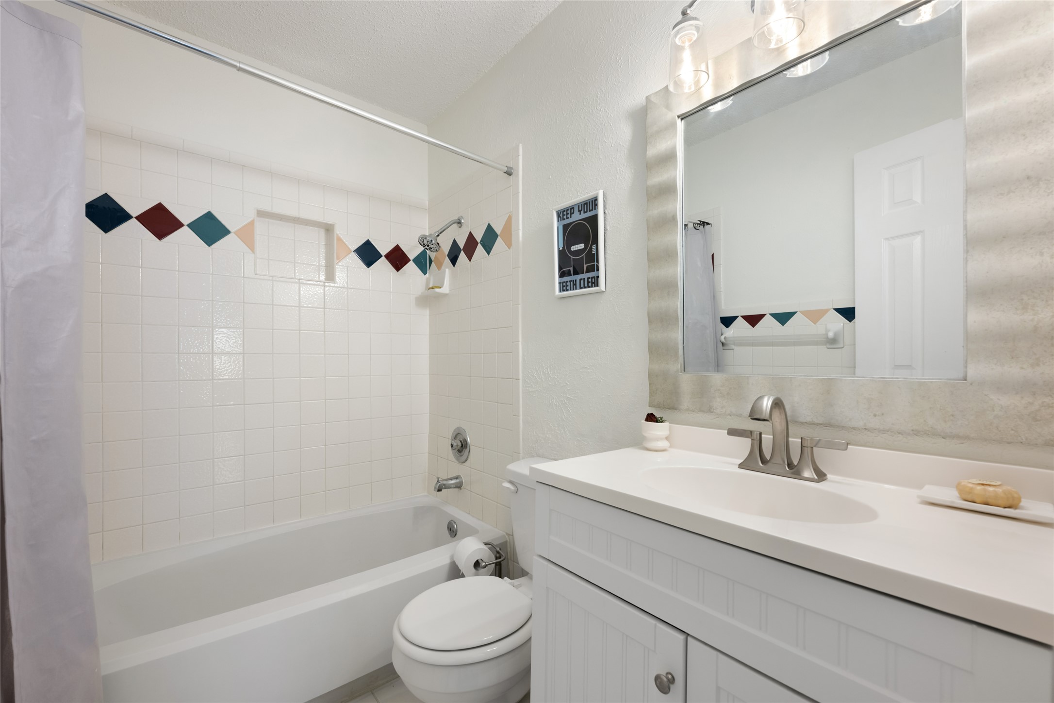 5100 Lambs Lane Austin, TX 78744 - Photo 18 of 31 Full bathroom downstairs with shower / tub combo and vanity.