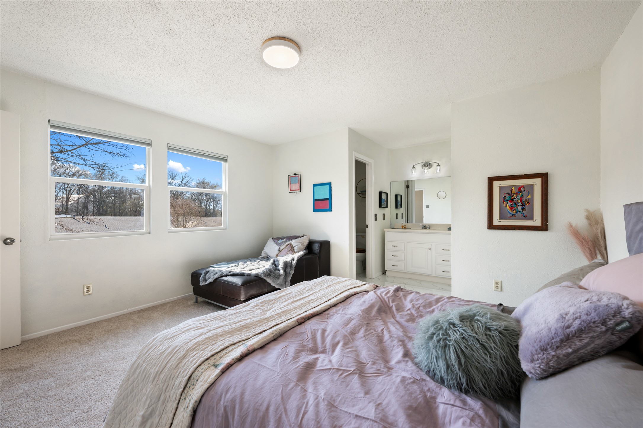 5100 Lambs Lane Austin, TX 78744 - Photo 21 of 31 Upstairs primary bedroom featuring fresh carpet and an ensuite bathroom.